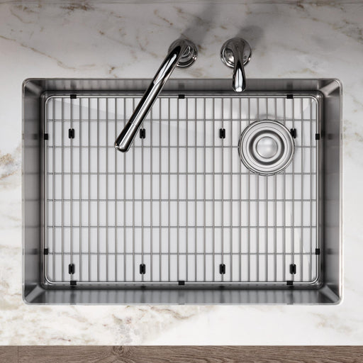 Overhead view of a large kitchen sink fitted with a stainless steel bottom grid