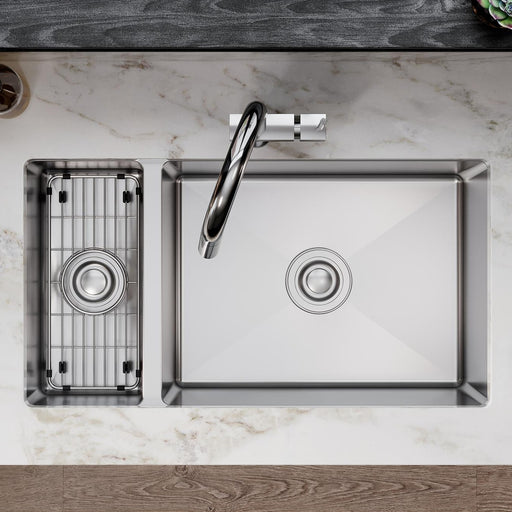 Stainless steel protective bottom grid fitted into the smaller bowl of a kitchen sink
