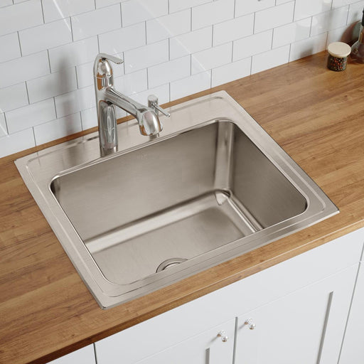 Stainless steel single-bowl sink installed in a wood countertop