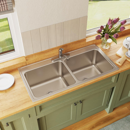 Stainless steel double-bowl kitchen sink installed in a countertop