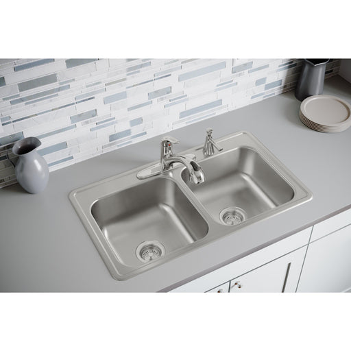 Angled view of an installed stainless steel double-bowl kitchen sink