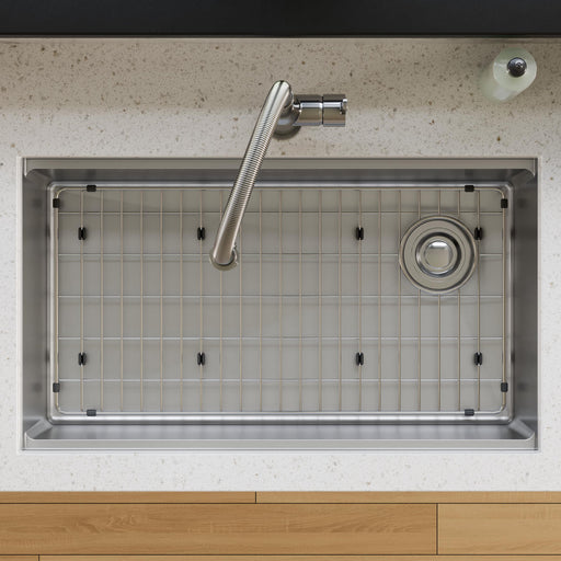 Stainless steel protective bottom grid fitted inside a rectangular kitchen sink