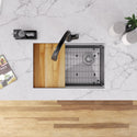 Overhead view of a workstation sink with cutting board, rack and grid