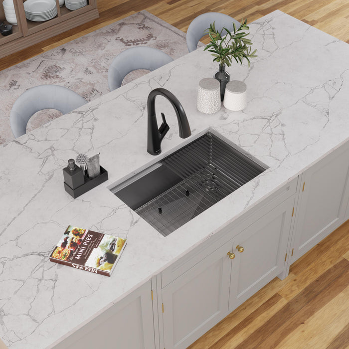 Stainless steel workstation sink with a roll-up rack and kitchen accessories