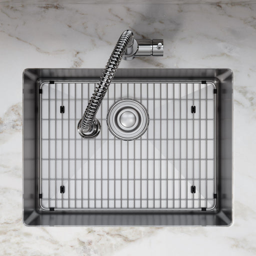 Square kitchen sink fitted with a stainless steel protective bottom grid