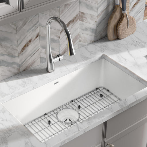 Large white single-bowl quartz kitchen sink fitted with a protective grid