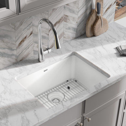 White single-bowl quartz kitchen sink fitted with a protective bottom grid