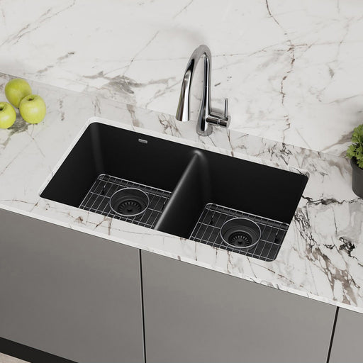 Black double-bowl quartz kitchen sink installed in a light countertop
