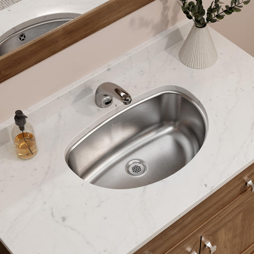 Oval stainless steel bathroom sink installed in a countertop