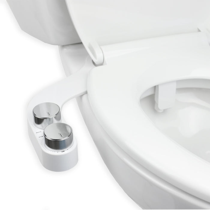 Brondell FSR-25 white FreshSpa installed beneath a toilet seat, with control knobs and nozzle visible