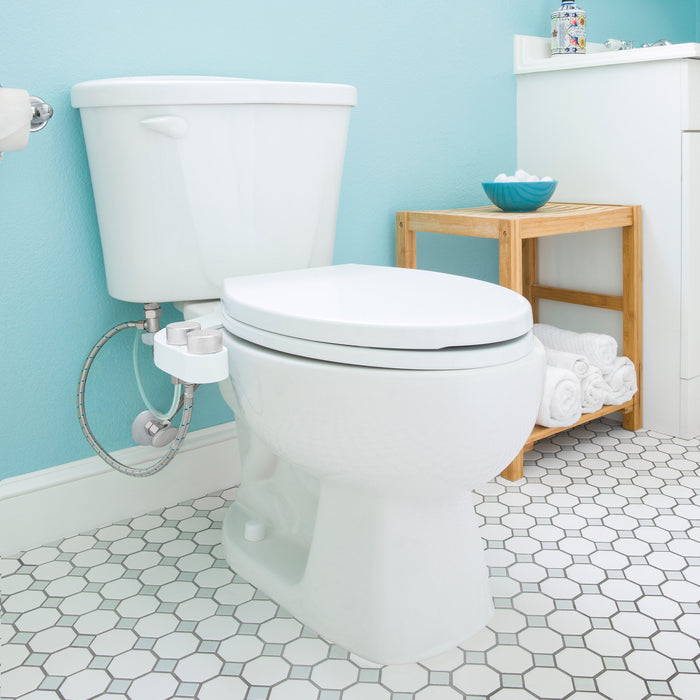 Brondell FSR-25 FreshSpa installed on a toilet in a blue bathroom with hexagonal floor tiles
