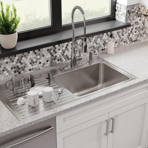 Elkay stainless steel kitchen sink with a ribbed integrated drainboard
