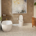 Brondell KBT-900 Coit smart toilet with raised lid in a tiled bathroom beside a freestanding bathtub