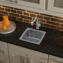 Small stainless steel kitchen sink and faucet installed in a dark countertop