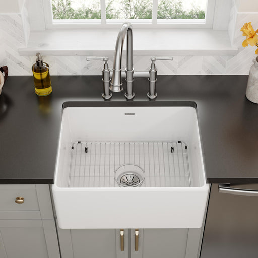 Stainless steel bottom grid placed in a farmhouse kitchen sink