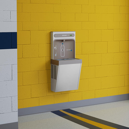 Elkay bottle filling station and fountain mounted on a yellow school hallway wall