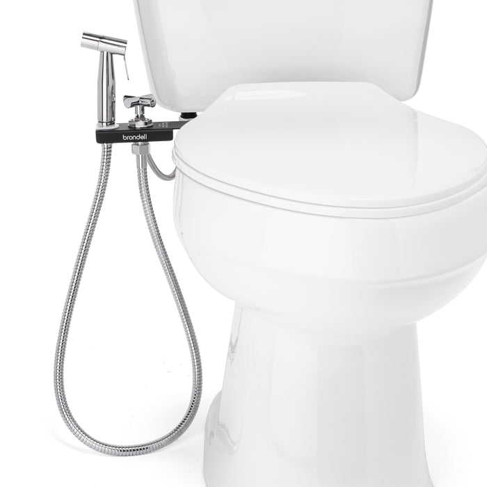 Brondell MBH-40-B black CleanSpa holster and handheld sprayer mounted beside a closed toilet seat