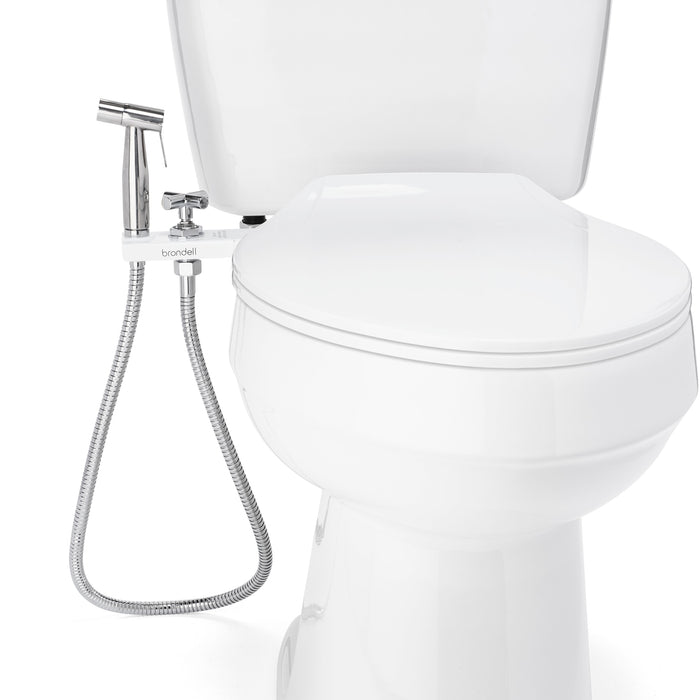 Brondell MBH-40-W close-up of the white CleanSpa holster and hanging sprayer hose beside a closed toilet seat