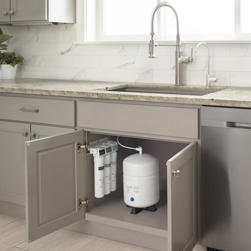 Brondell RC250 Capella filters and tank inside an open gray kitchen sink cabinet