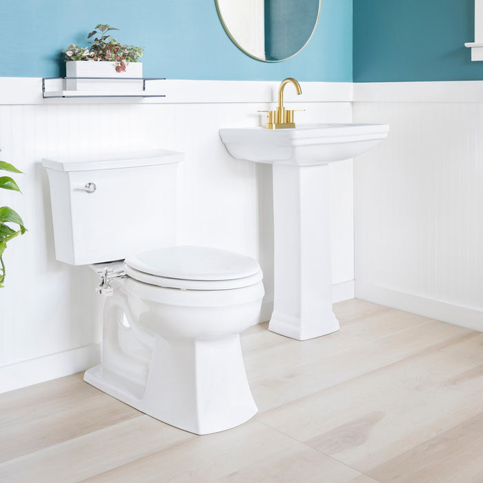 Brondell SMB-15 chrome side-mounted bidet installed in a bathroom beside a pedestal sink