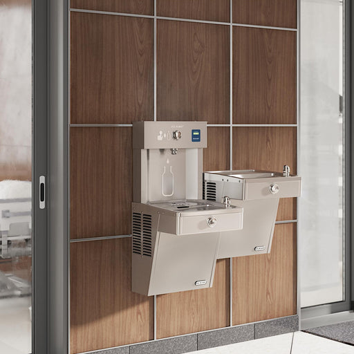 Elkay bi-level bottle filling station and drinking fountains installed against a tiled wall